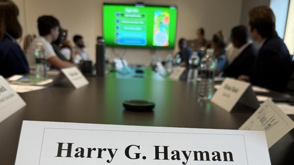 A Feed Philly Coalition policy meeting around a conference table, with a place card reading Harry G. Hayman